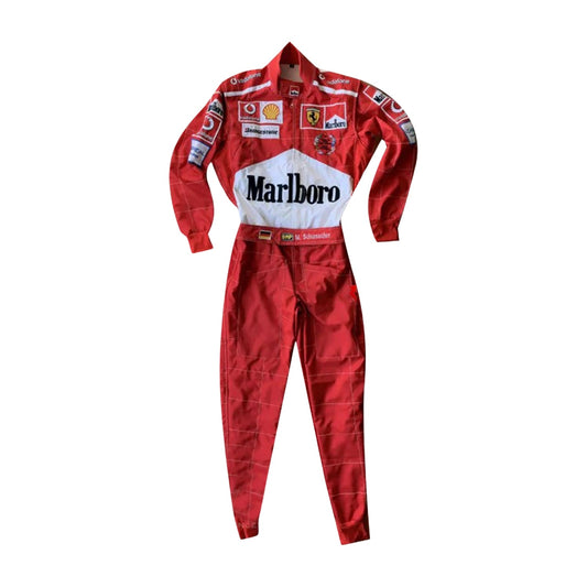 Front view of Michael Schumacher’s 2005 F1 racing suit in signature Ferrari red, with intricate white embroidery and sponsor detailing from the 2005 season.