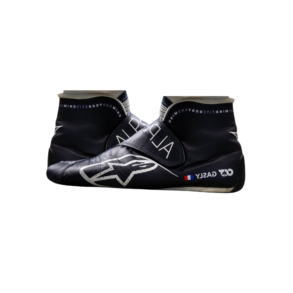 Black and gray Pierre Gasly 2022 F1 Racing shoes with branding on a white background