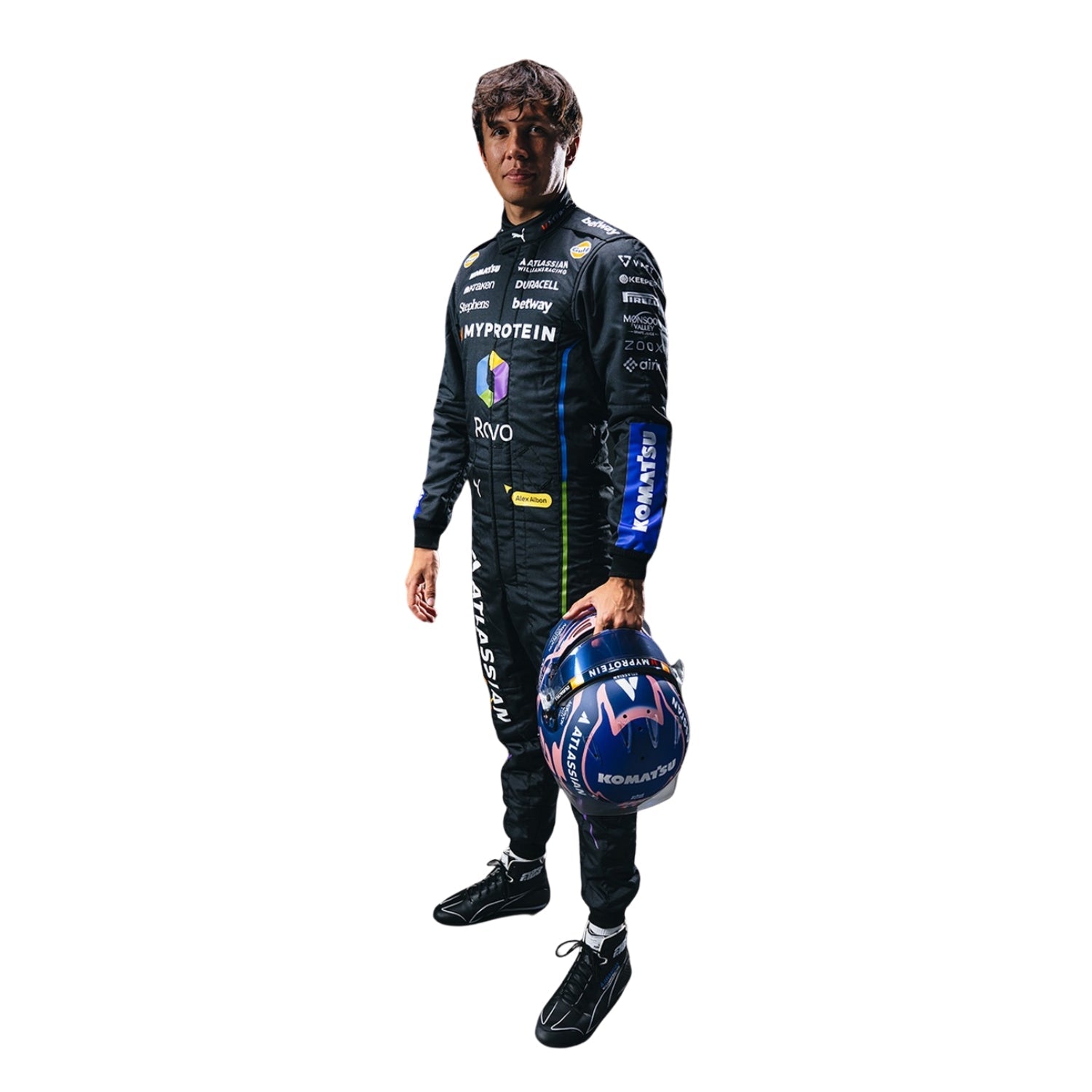 Alexander wearing a 2025 las vegas racing suit holding a helmet on a white background