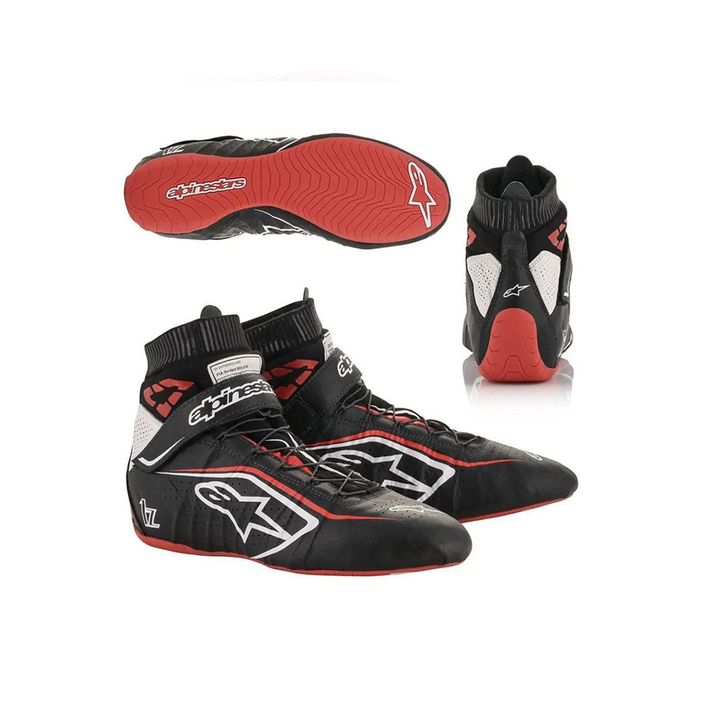 Black and red Alpinestars Tech1-Zv2 racing shoes with a prominent brand logo on a white background