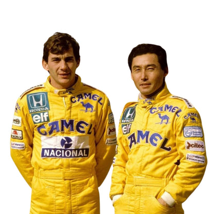 Close-up shot of the 1987 F1 racing suit worn by Ayrton Senna, highlighting premium stitching, fabric texture, and colorful sponsor logos.