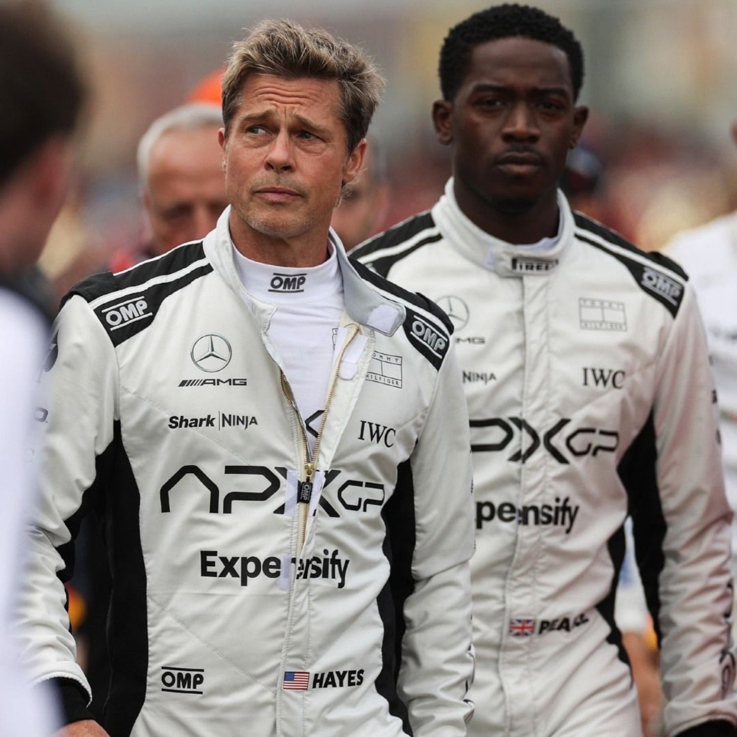 Detailed close-up of the 2025 F1 The Movie racing suit fabric, stitching, and logos for authentic racing style.
