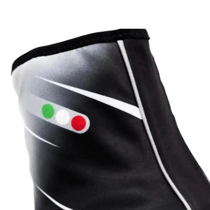 Black Freem Yeti shoe covers with green, white, and red buttons on a white background