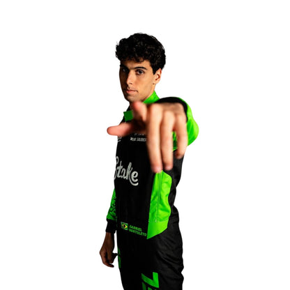 Gabriel Bortoleto standing in his 2025 racing suit, showing off the professional fit and bold design.

