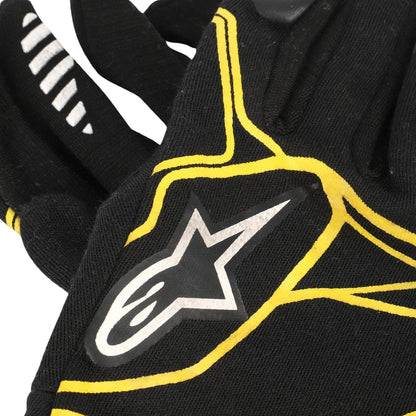 Kevin Magnussen 2016 Black F1 Racing glove with yellow accents and a star logo on a white background