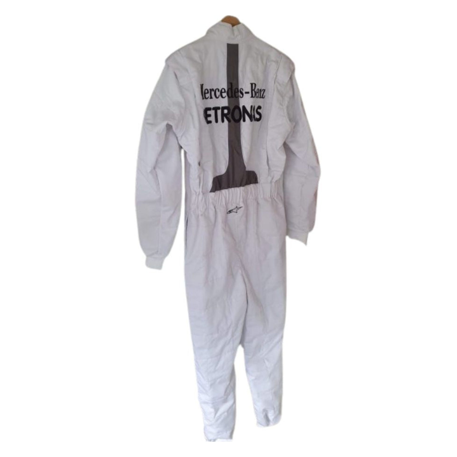 Rear view of Schumacher’s 2011 race suit with full silver finish, featuring name embroidery and aerodynamic panel construction.